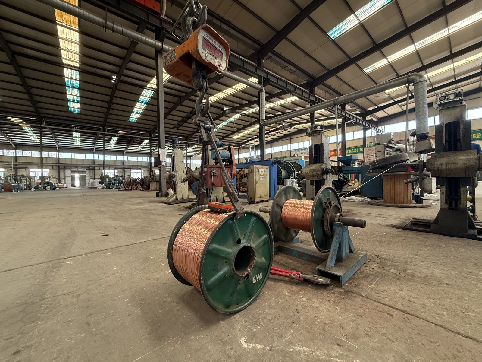 Copper conductor reels beside production machinery at Zhongde